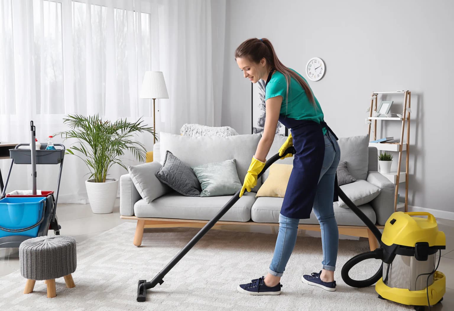 Cleaning professional vacuuming a bright living room